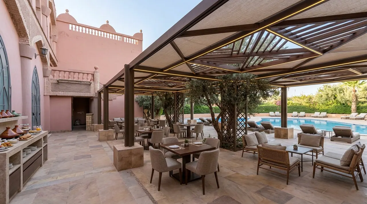Outdoor patio dining area looking onto the pool and pink-walled architecture
